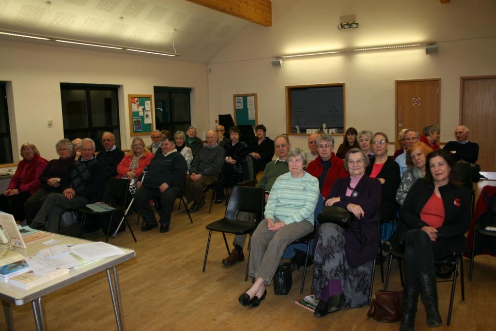 A group of people sat in a hall