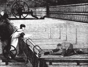 A 'scavenger' sweeping cotton fluff from under a spinning mule.