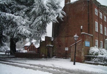 A building and tree covered in snow.